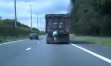 Cyclist Going 60 MPH Behind A Truck (Video)