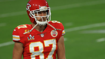 Travis Kelce wearing his helmet and number 87 jersey in a game