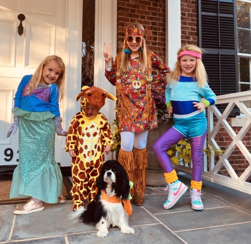 Eli manning's children all dressed up for Halloween on their front porch.