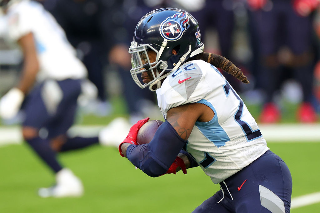 Tennessee Titans running back Derrick Henry running with the football, with his hair visible outside of his helmet