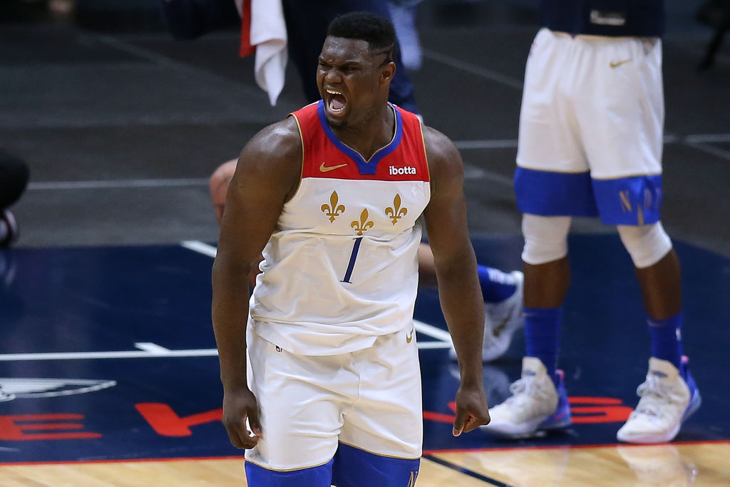 Zion Williamson in a basketball game making a yelling face.