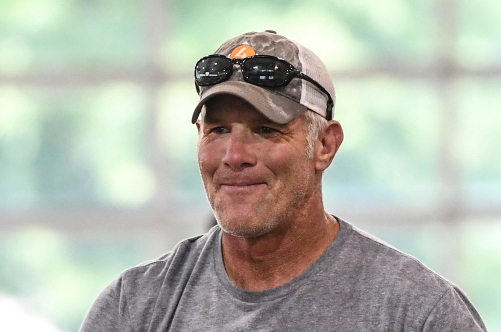 Brett Favre smiling with cap and glasses on head