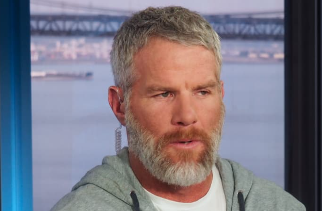 Brett Favre with earpiece in during interview