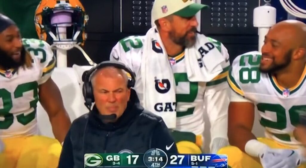 Aaron Rodgers, Aaron Jones and AJ Dillon laugh on the Packers bench.