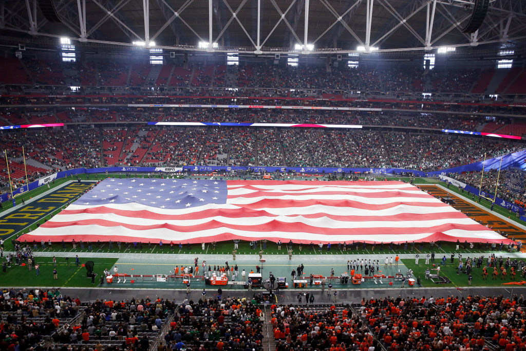 A huge American flag covering a football field