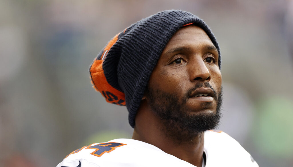 Defensive End Robert Quinn watched his team while wearing a winter hat.