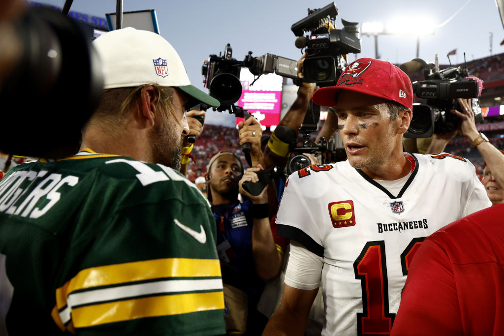 Tom Brady, Aaron Rodgers shaking hands without helmets on