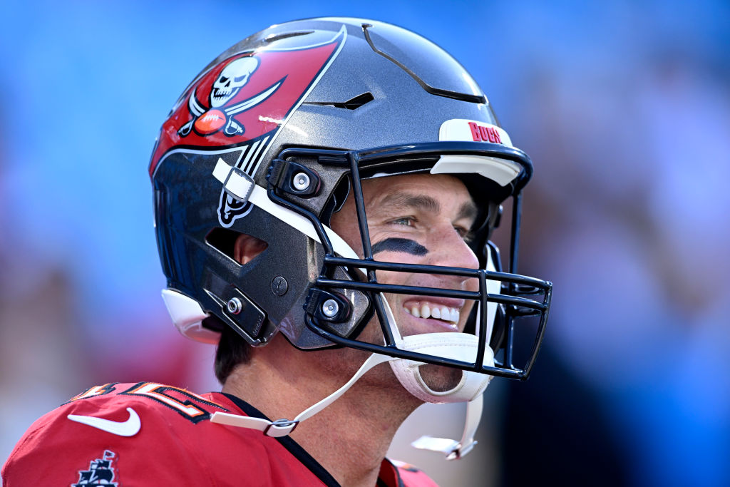 Tom Brady with helmet on smiling