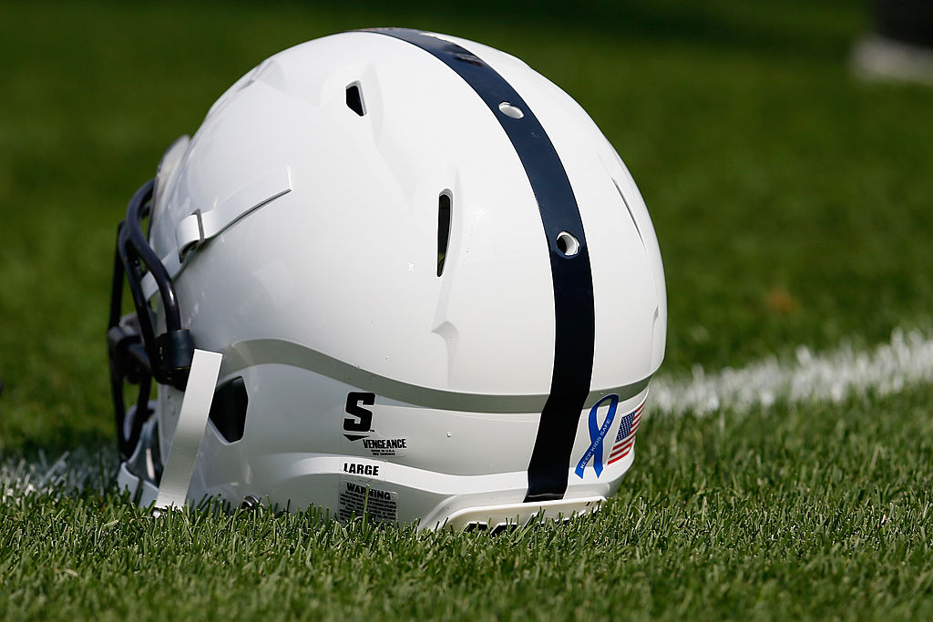 Penn State Nittany Lions helmet seated on the grass
