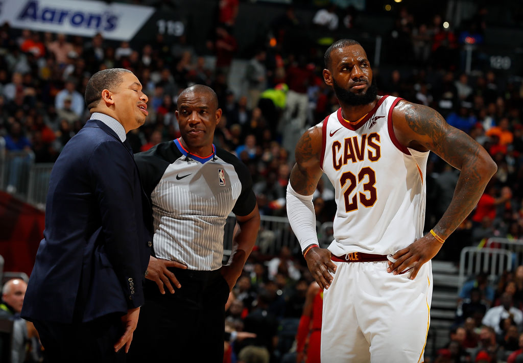 Ref Tony Brown stands with Tyronn Lue and Lebron James