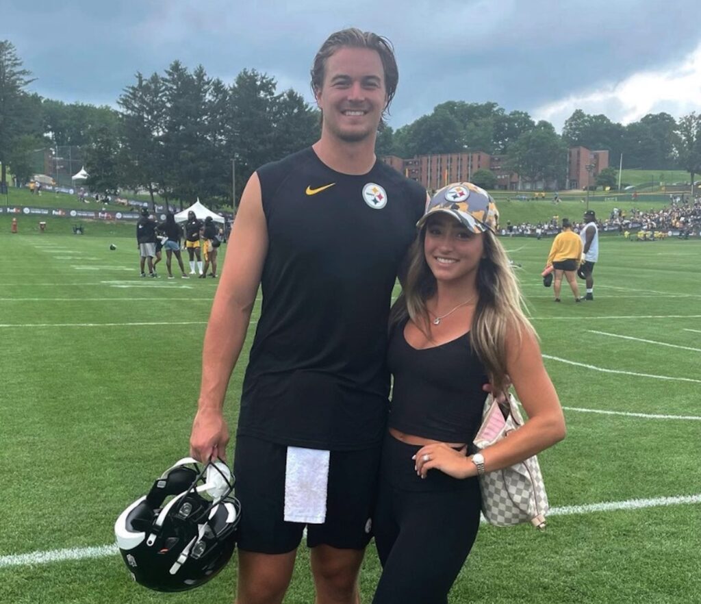 Kenny Pickett with his arm around fiance Amy Paternoster, both sporting Steelers clothing.