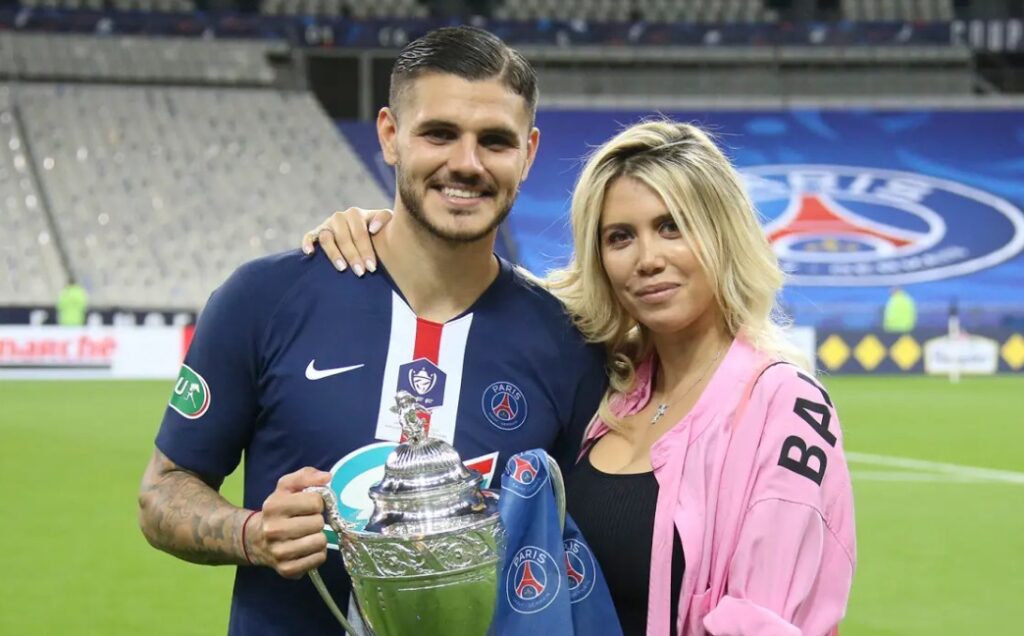 Mauro Icardi and wife Wanda pose by soccer trophy