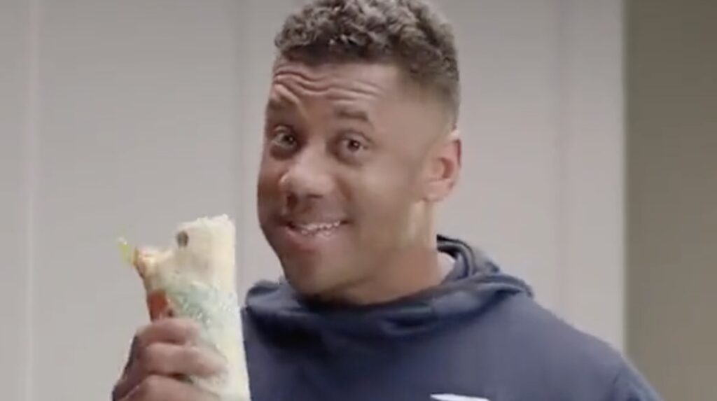 Russell Wilson holds up his Dangerwich sandwich in a Subway commercial. 