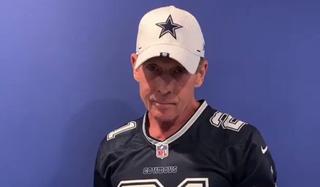 Skip Bayless poses in his Cowboys had and jersey.