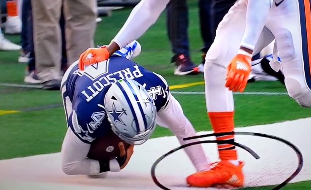 Cowboys QB Dak Prescott gets his hand stepped on while on the ground.