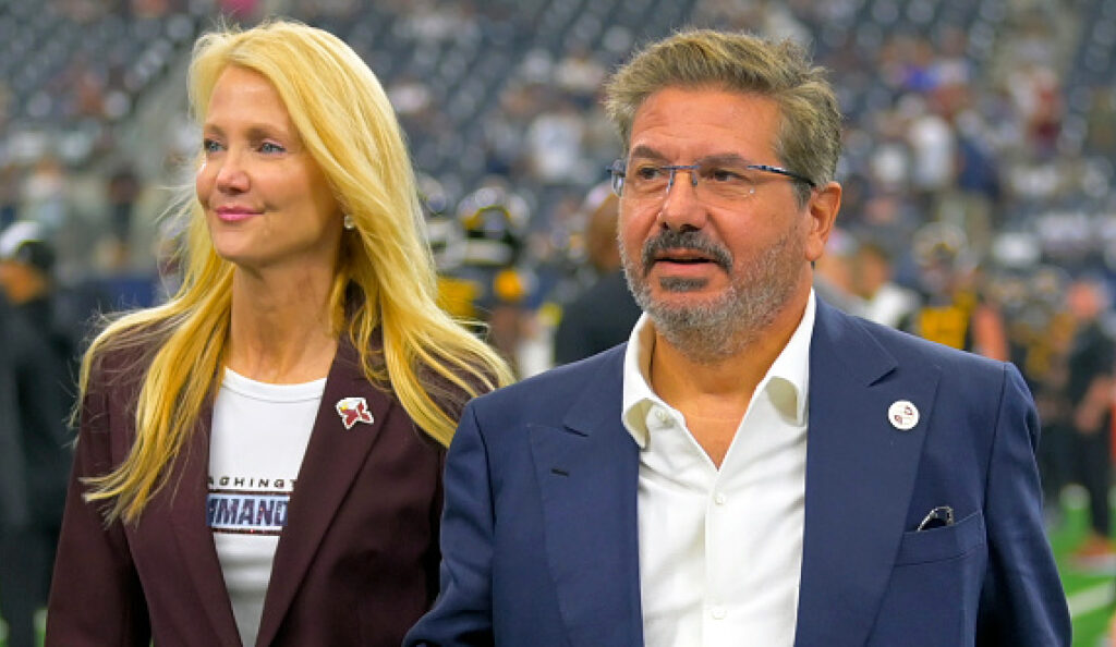 Washington Commanders owners Tanya Snyder, left, and Dan Snyder on the field before the Dallas Cowboys game.