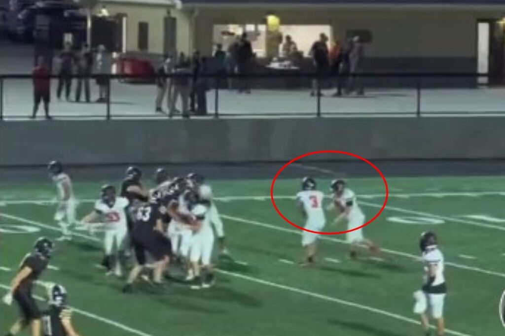 Disabled kid receiving handoff during football game