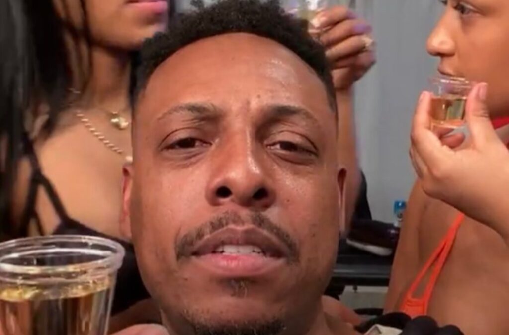 Paul Pierce looks on from Instagram Live while strippers behind him
