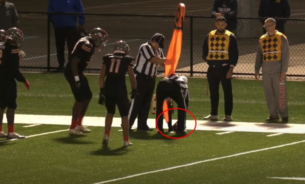 ref spotting football in front of down marker