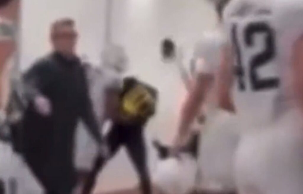 Spartans players assaulting Michigan player