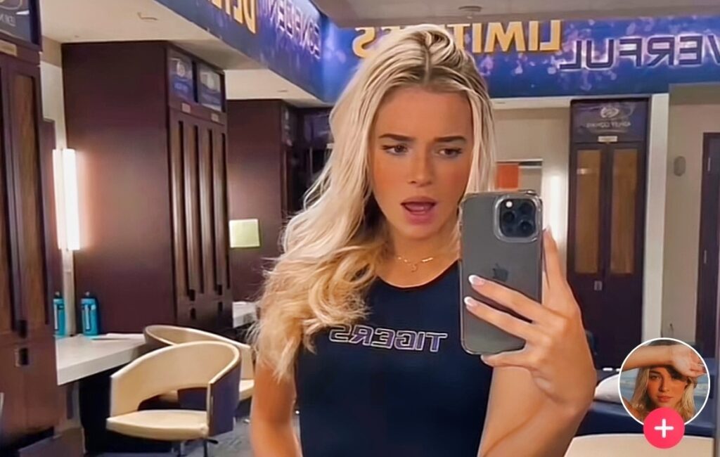 Olivia Dunne holding phone in locker room