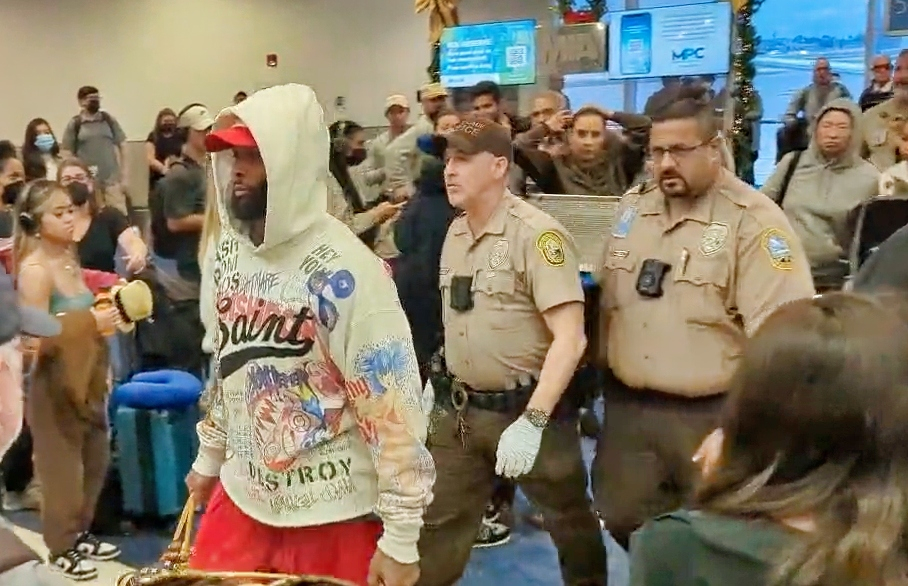 OBJ getting escorted off plane by police.