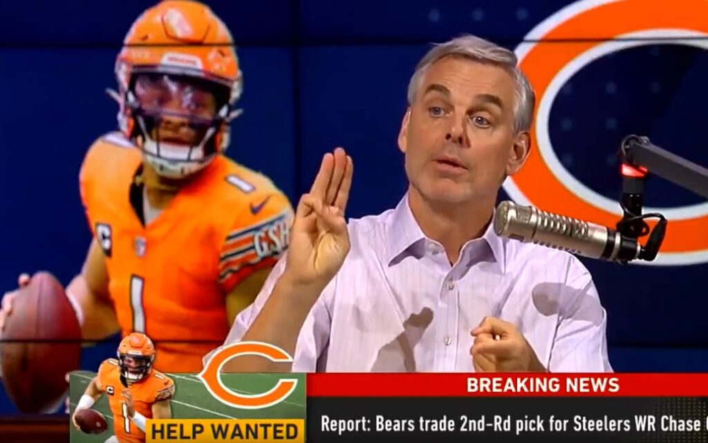 Colin Cowherd with his hand showing 3 fingers while a picture of Justin Fields is behind him
