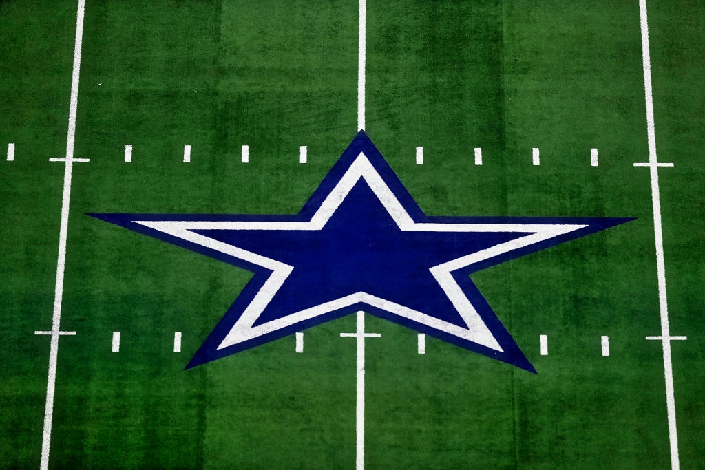 Dallas Cowboys logo at midfield AT&T Stadium.