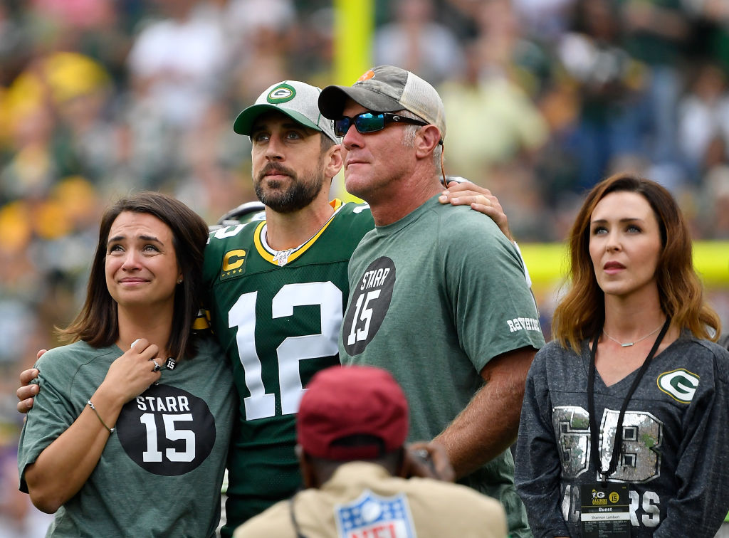 Aaron Rodgers and Brett Favre standing next to each other