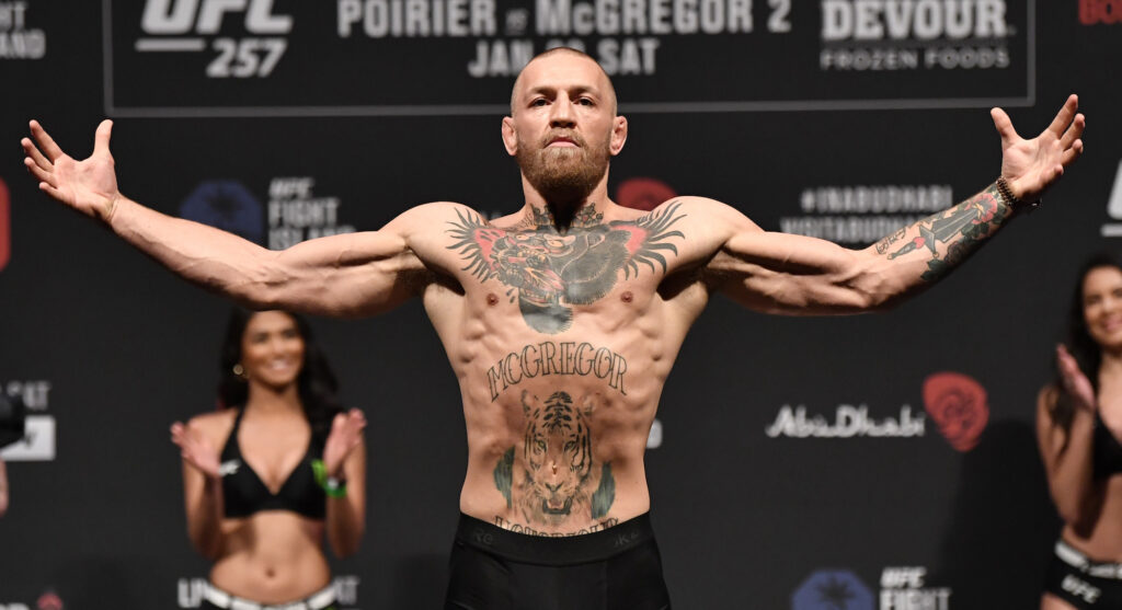 Conor McGregor poses at a weigh-in