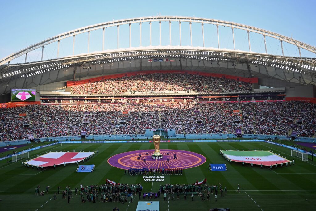 A general view shows England and Iran players listening to their national anthems during the Qatar 2022 World Cup