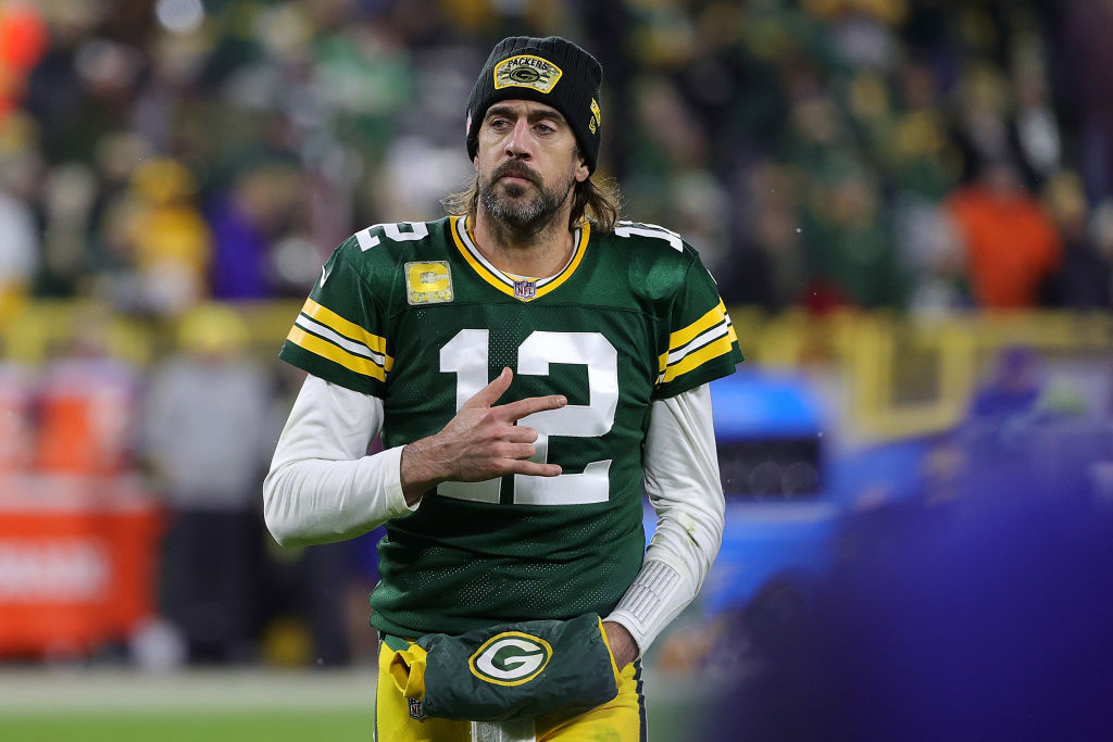 Aaron Rodgers making hand gesture while in uniform on field
