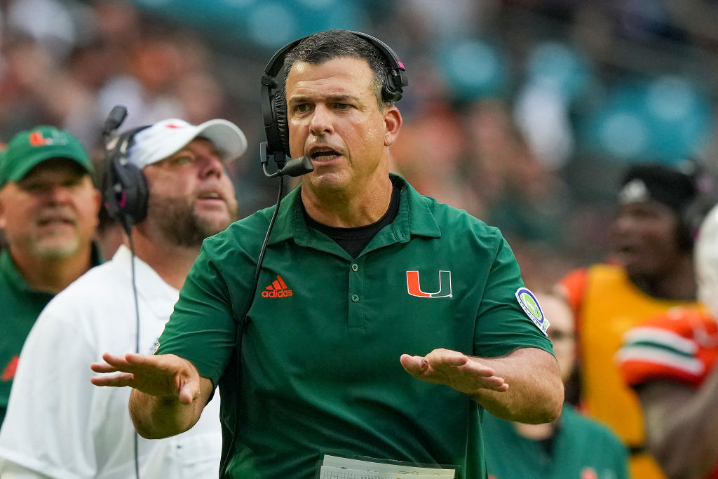 Mario Cristobal with his hands out