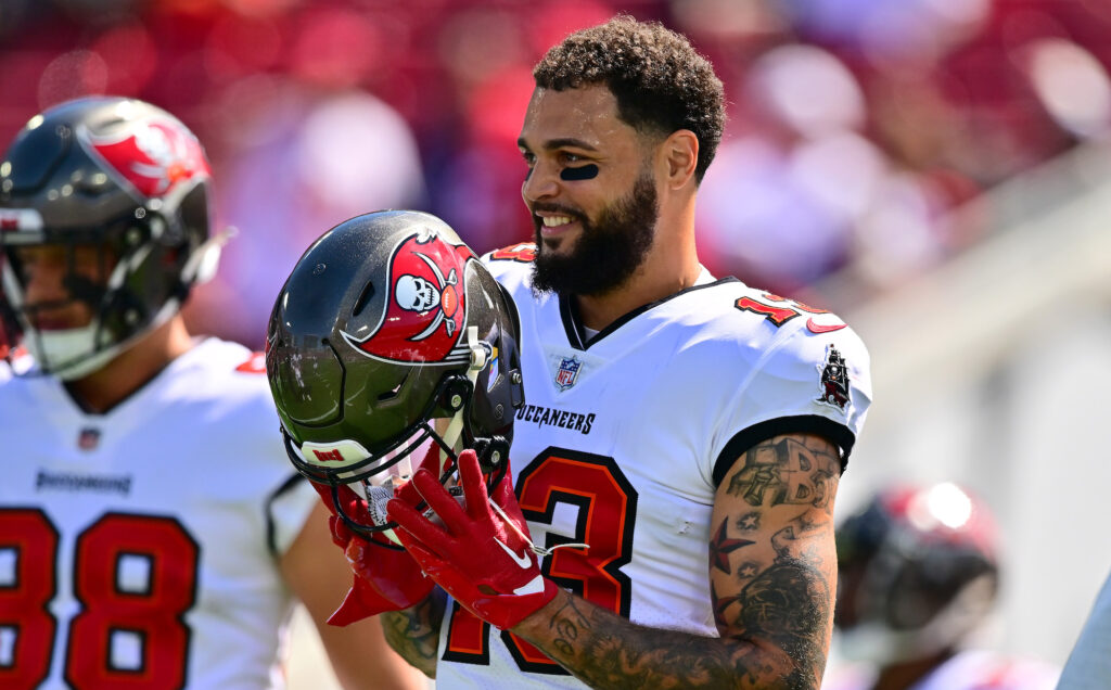Bucs wide receiver Mike Evans smiles with his helmet off.