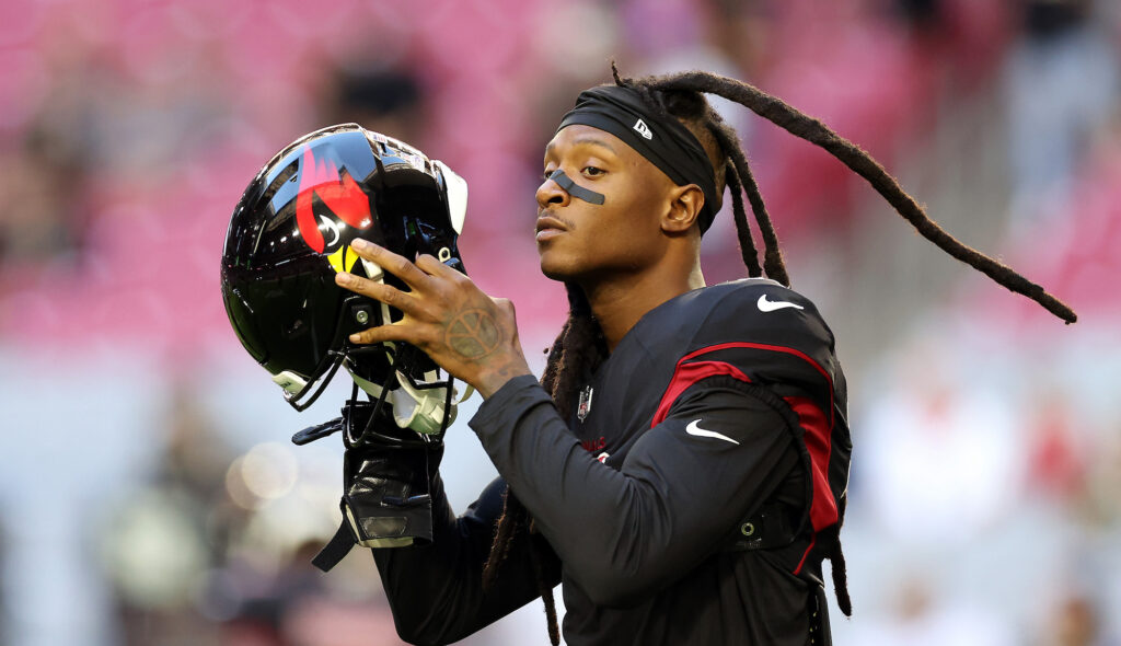 Cardinals wide receiver DeAndre Hopkins removes his helmet during a game.