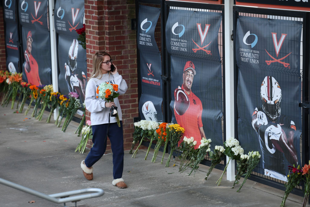 University of Virginia student walking by memorial