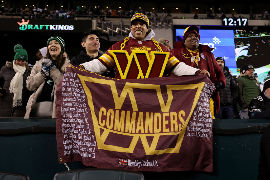 Washington Commanders fan holding flag