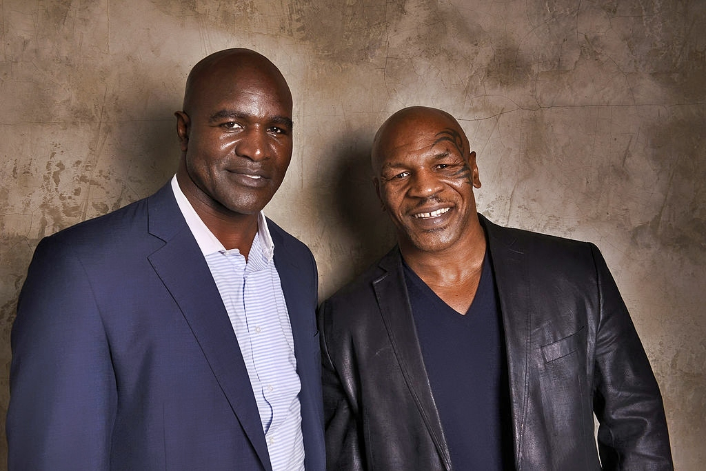 Mike Tyson and Evander Holyfield standing next to eachother.