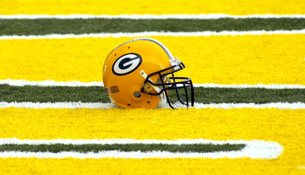 A Green Bay PAckers helmet on the field.