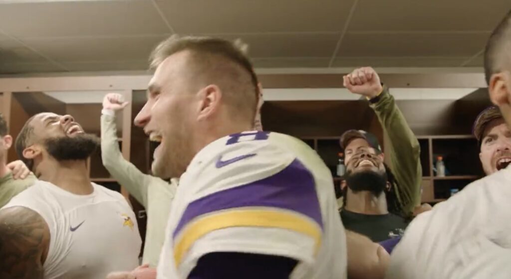 Vikings QB Kidk Cousins Celebrates a win with teammates in the locker room.
