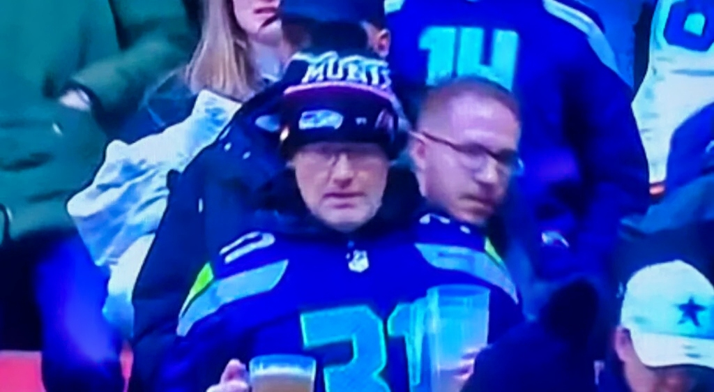 Seahawks fan holds a beer.