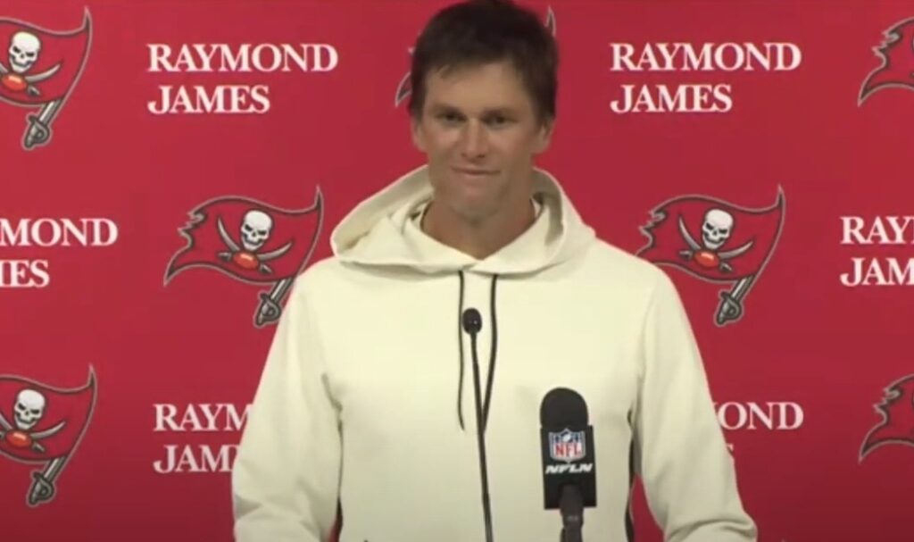 Tom Brady smiling at podium