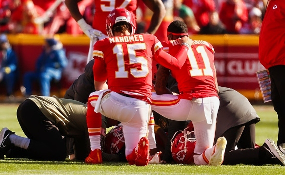 Kansas City Chiefs quarterback Patrick Mahomes (15) and wide receiver Marquez Valdes-Scantling (11) kneel by JuJu Smith-Schuster (9) as he lays on the ground