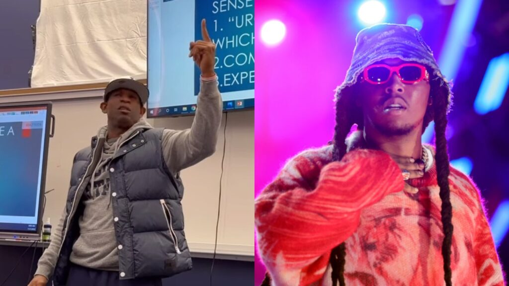 Deion Sanders pointing while standing while rapper Migos has glasses on and looking at crowd