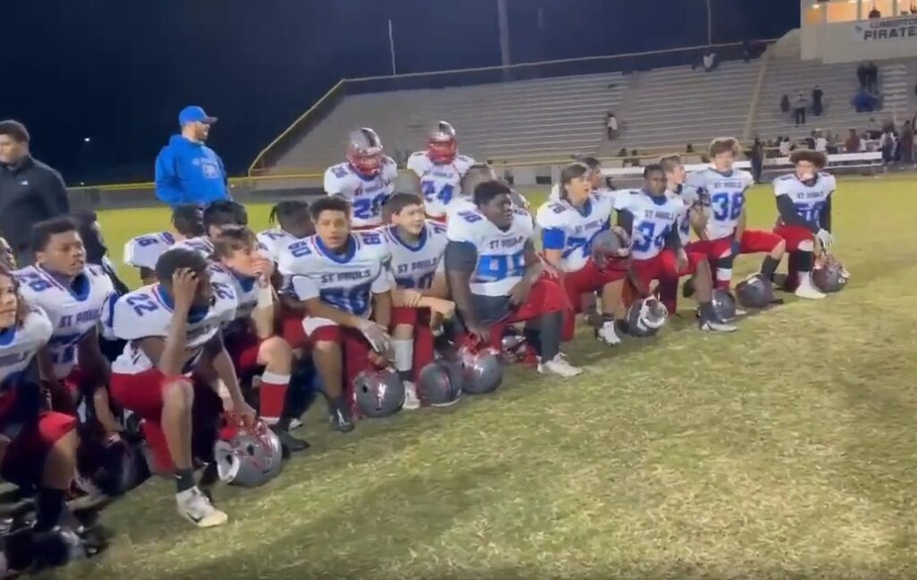high school players kneeling
