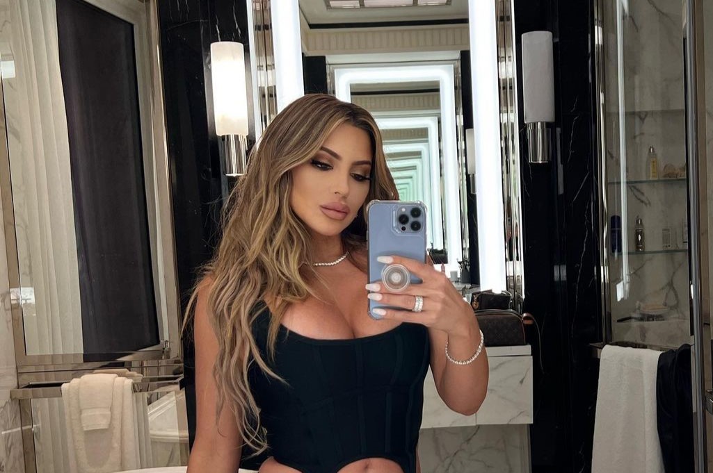 Larsa Pippen taking selfie with phone in her hand