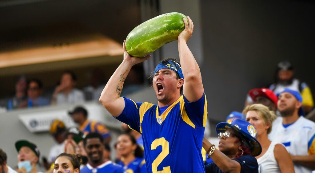 An angry Rams fan holding a watermelon.