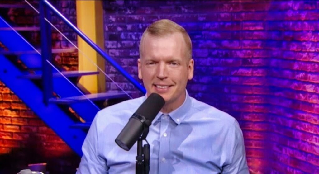 Chris Simms speaking during a talk show on the mic.