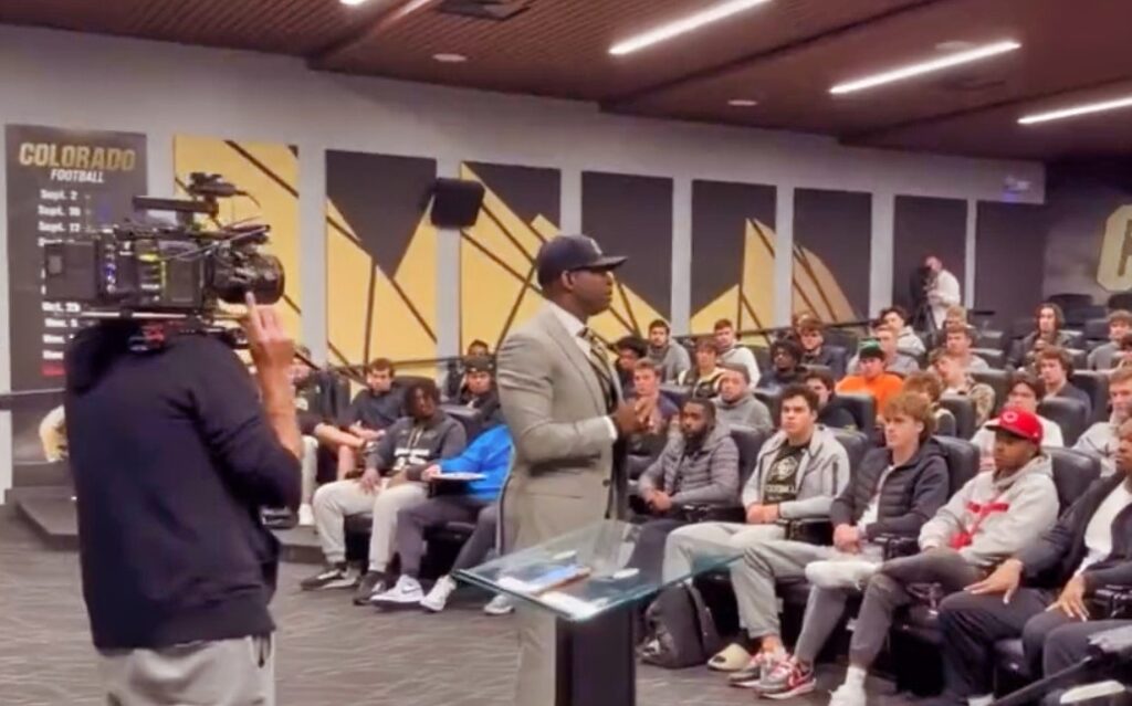 Deion Sanders speaking in front of players