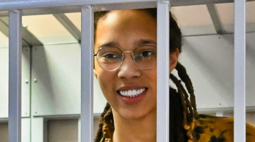 Brittney Griner smiling behind bars